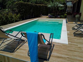 Pool with deck chairs for relaxation