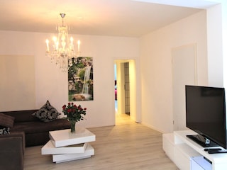 Wohnbereich mit Flat-TV und Schreibtisch