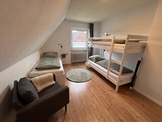 Schlafzimmer 4 mit Etagenbett, Einzelbett und Sessel