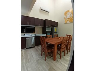 Kitchen with dining set made of Guanacaste wood