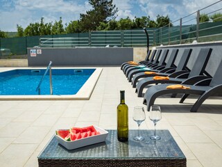Sun loungers next to private pool of villa