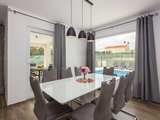Dining area with pool view in Villa Greta