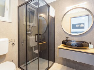 Bathroom with walk in shower and wash basin