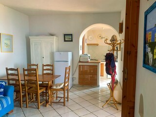 Dining area with blue sofa and fireplace