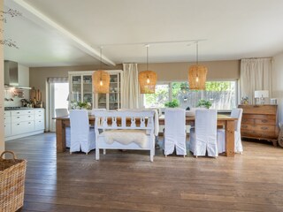 The large dining table and the spacious open kitchen