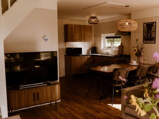 Living room with TV and open kitchen