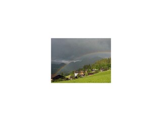 Regenbogen über den Reither Almen