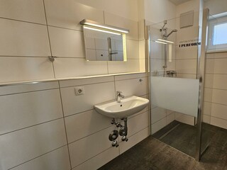 Badezimmer mit Dusche und Waschbecken