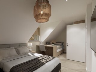 Schlafzimmer mit Doppelbett und TV - Beispielbild