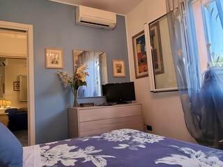 Bedroom with double bed and air conditioner