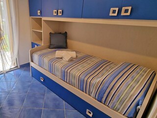 Bedroom with single bed and extra bed