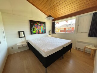 Room 01: bright, friendly. Double bed. Wooden floor