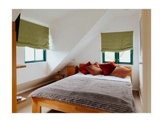 Traveblick- Schlafbereich mit komfortablem Doppelbett