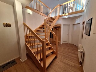 Treppe zum Wohnraum, links unten Bad, rechts die Küche